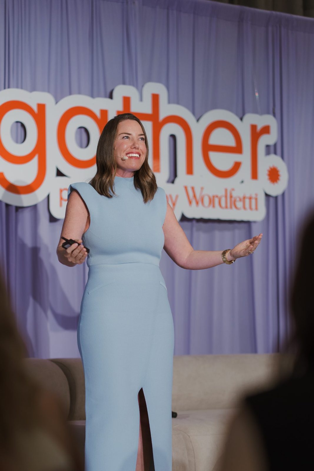 Tina Tower speaking on stage at Gather